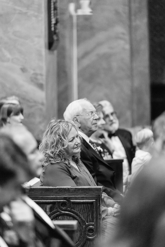 Guests seated inside Saint Clement Parish watching the wedding ceremony unfold.