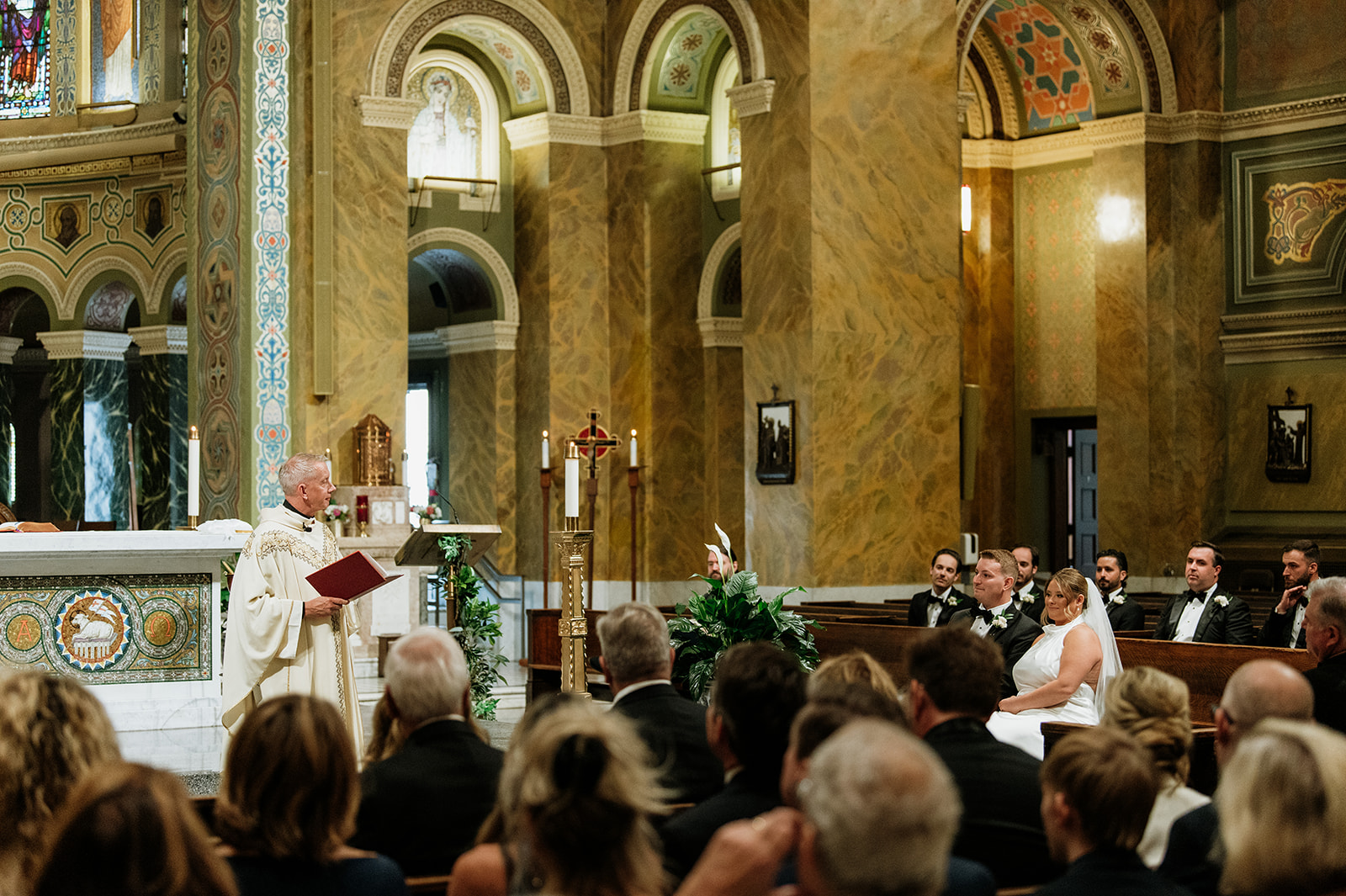 Priest delivering a heartfelt homily during a Catholic wedding ceremony at Saint Clement Parish in Chicago.