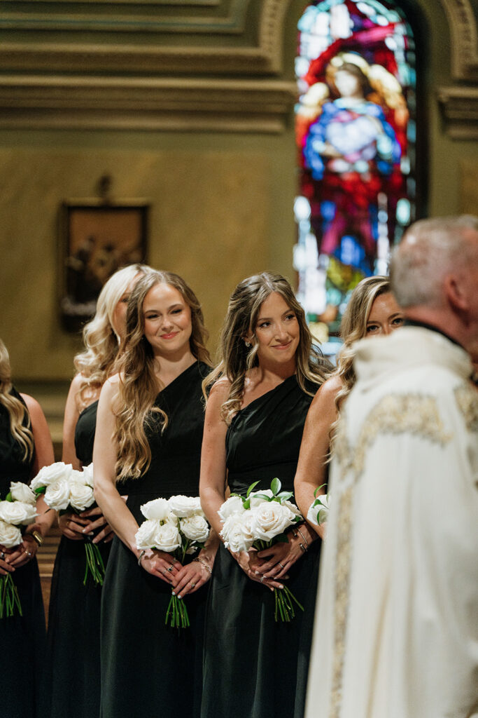 Bridesmaids smiling during a Saint Clement Parish wedding ceremony in Chicago.