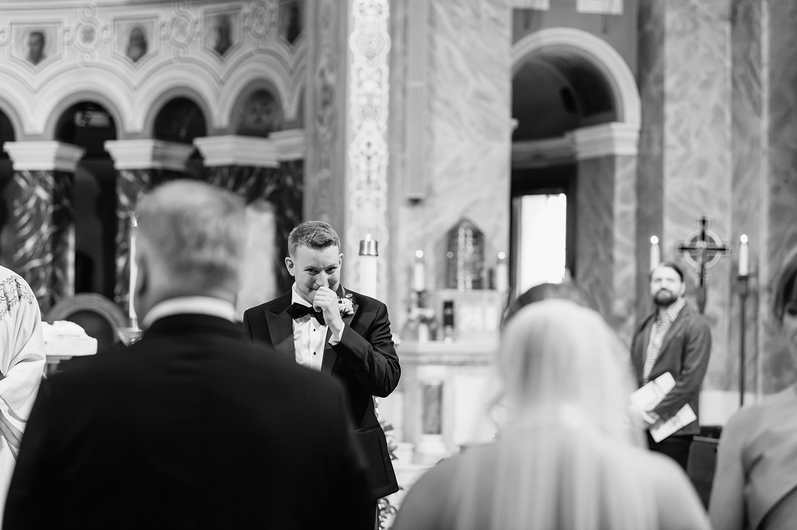 Emotional moment as the groom reacts during the Catholic wedding ceremony at Saint Clement Parish.