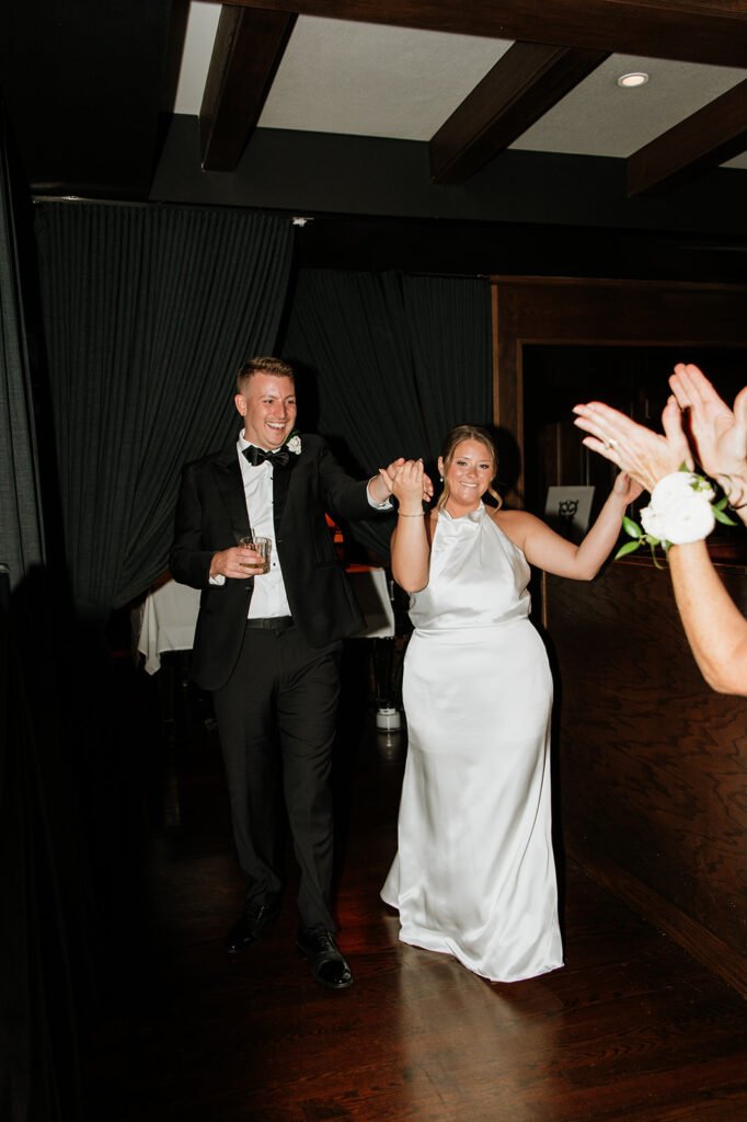 Bride and groom entering their cocktail party at Tortoise Supper Club in Chicago.