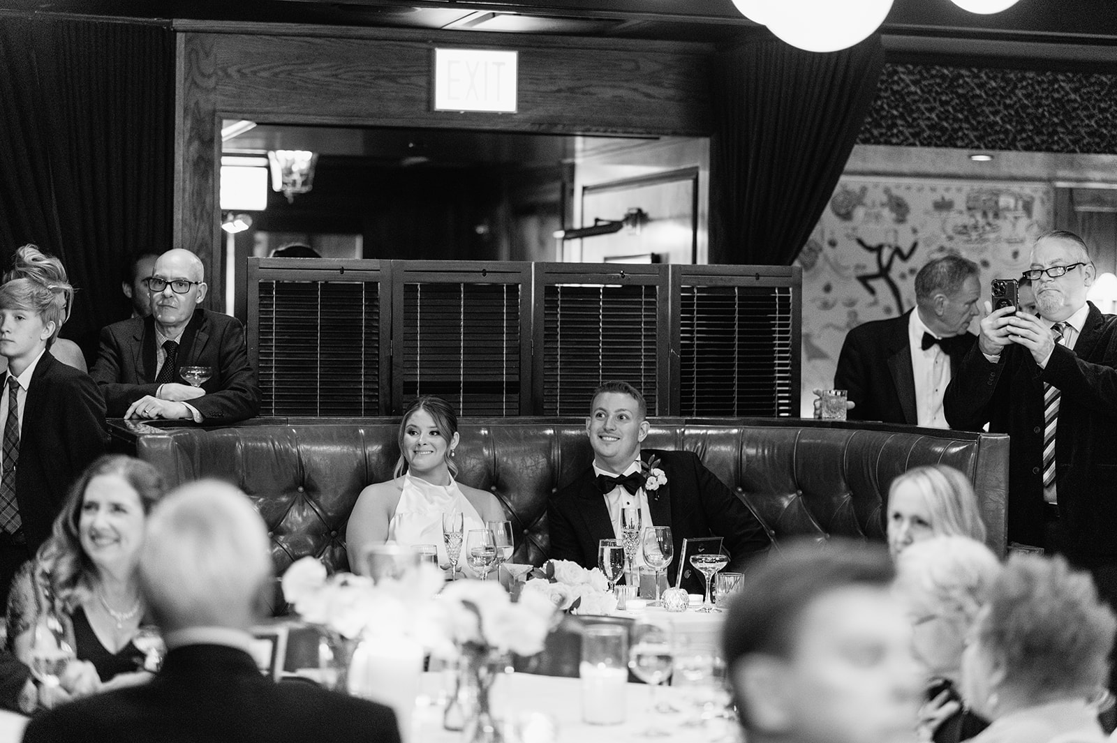 Guests gathered around the couple during an intimate Tortoise Supper Club wedding reception.