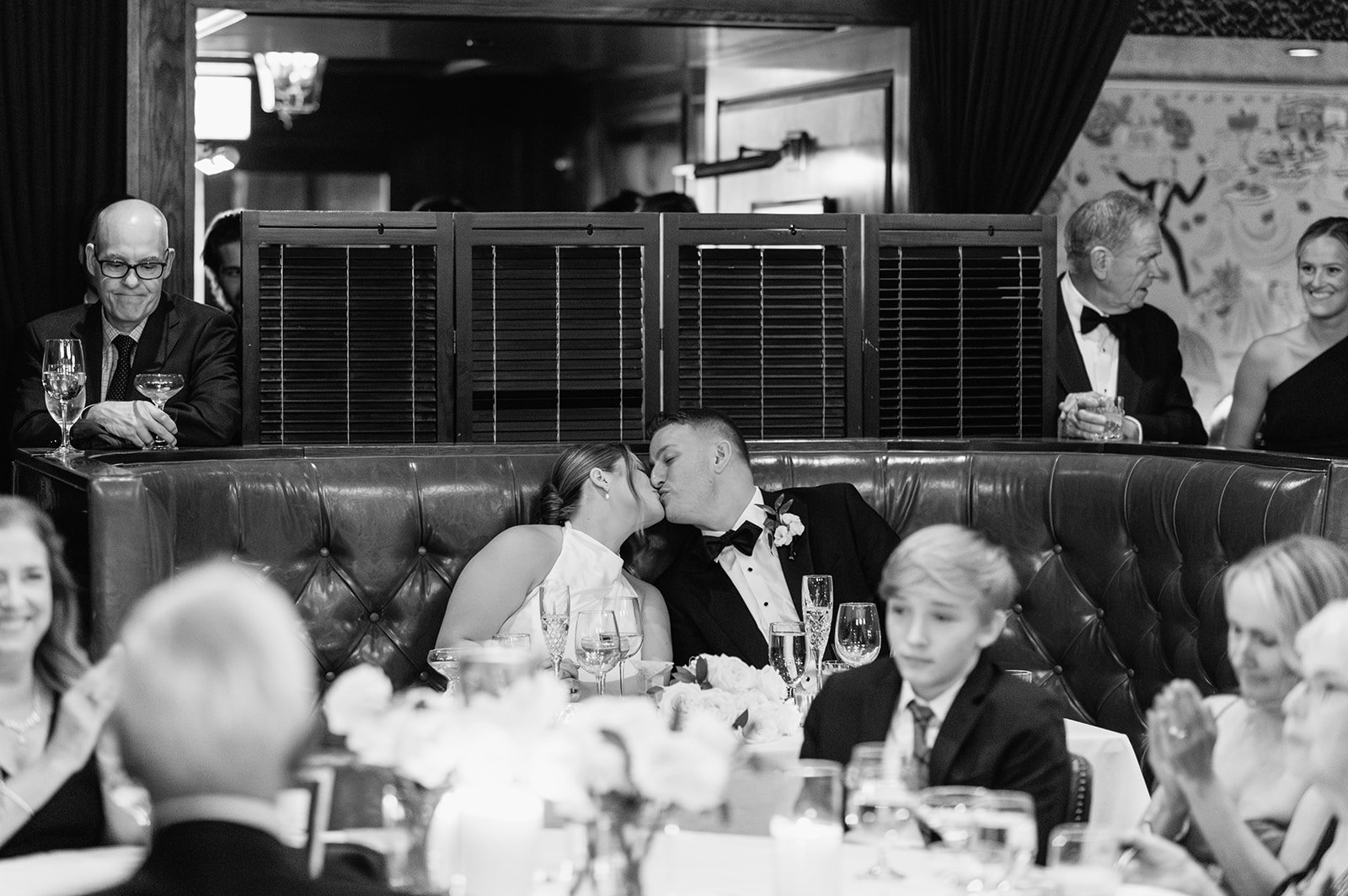 Black and white photo of a bride and groom kissing during their Tortoise Supper Club wedding cocktail party in Chicago.