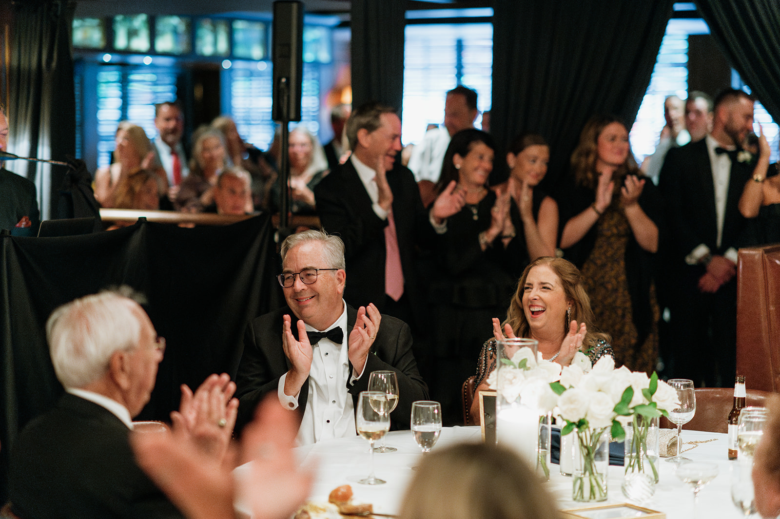Guests clapping during speeches from a Tortoise Supper Club wedding cocktail party in Chicago.