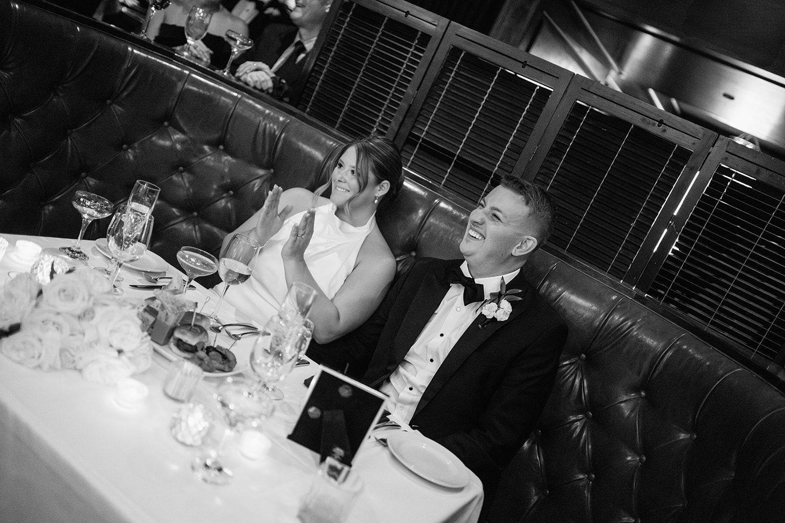 Couple laughing during toasts at their Tortoise Supper Club wedding cocktail party in Chicago.