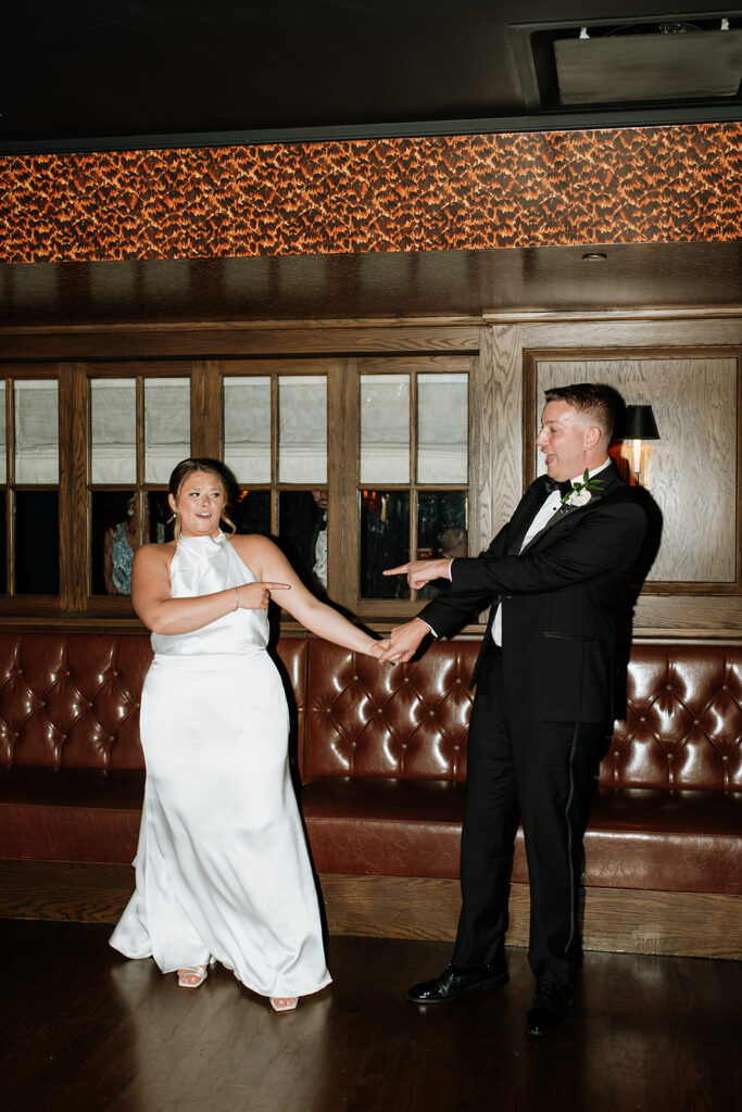 Bride and groom sharing a playful moment on the dance floor at Tortoise Supper Club.