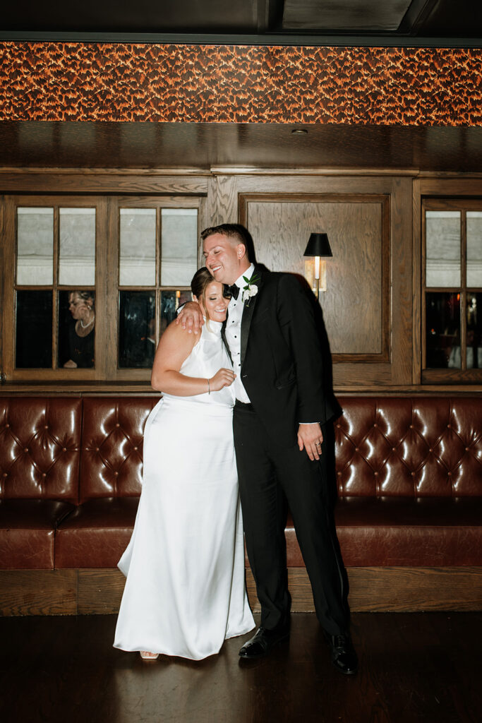 Bride and groom hugging after dancing.