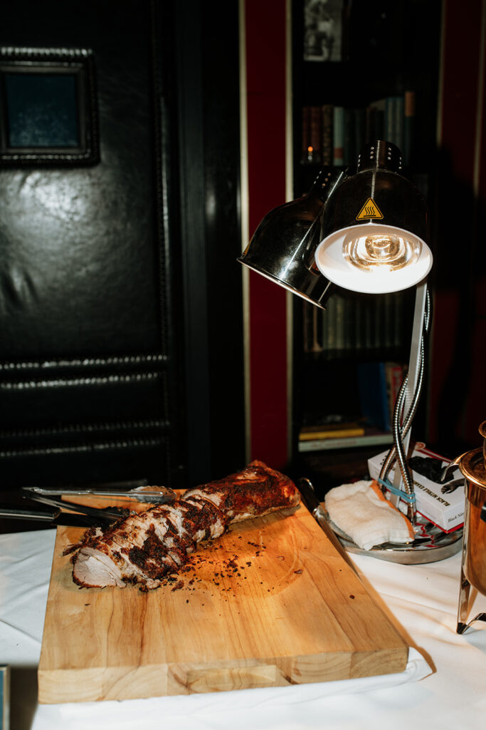 Carved meat station set up for dinner during a Tortoise Supper Club wedding reception.
