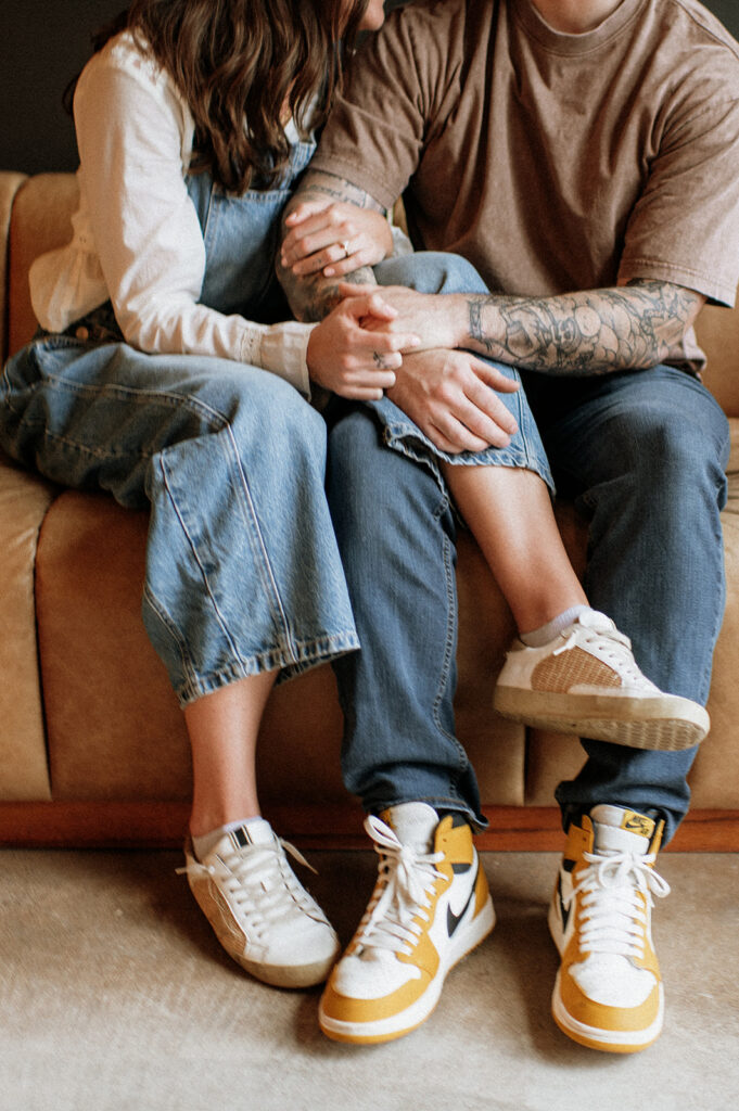 Close-up portrait of couple sitting together on couch during antique shop engagement photos.