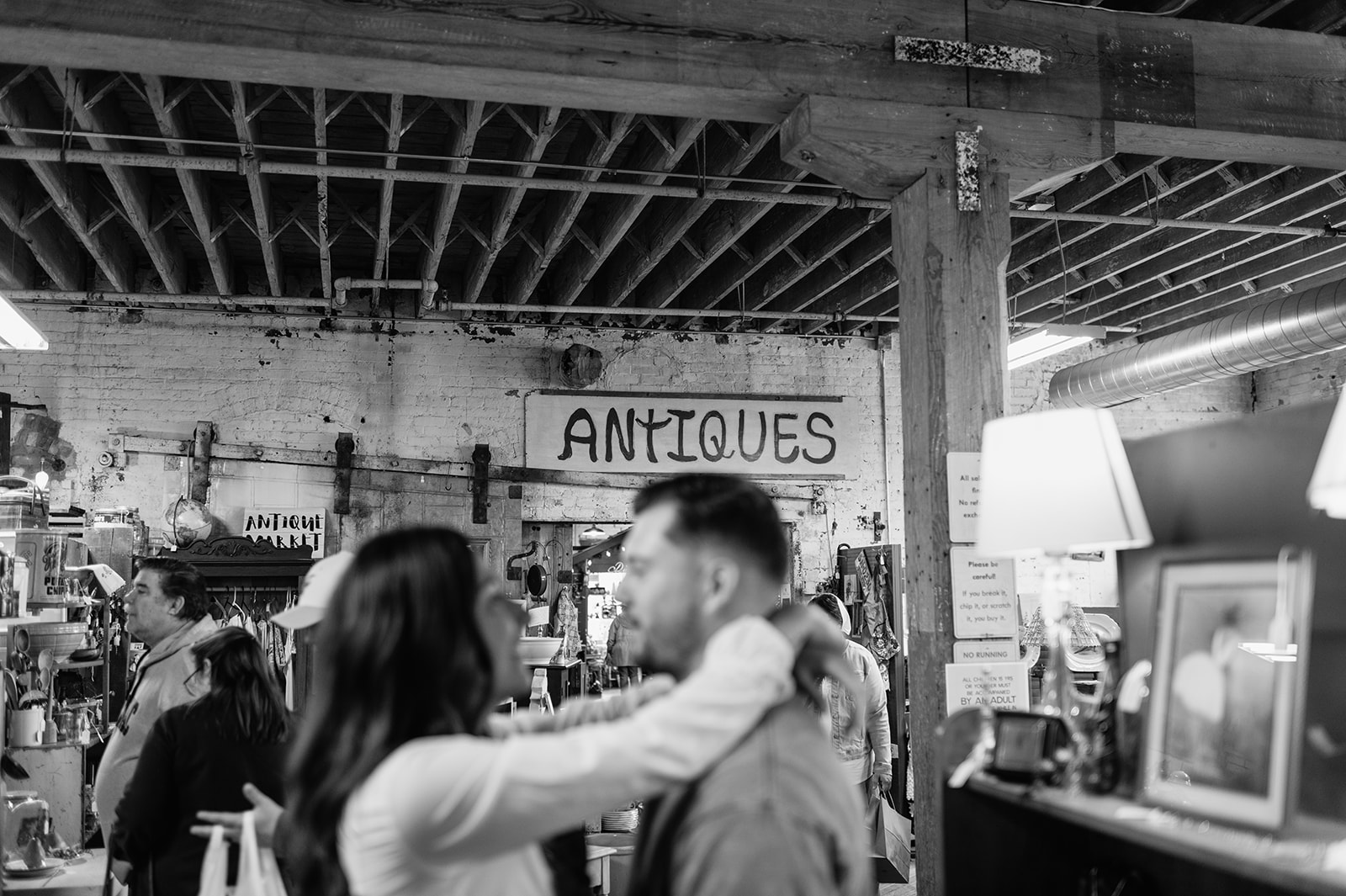 Couple posing for their antique store engagement photos near South Bend, Indiana.