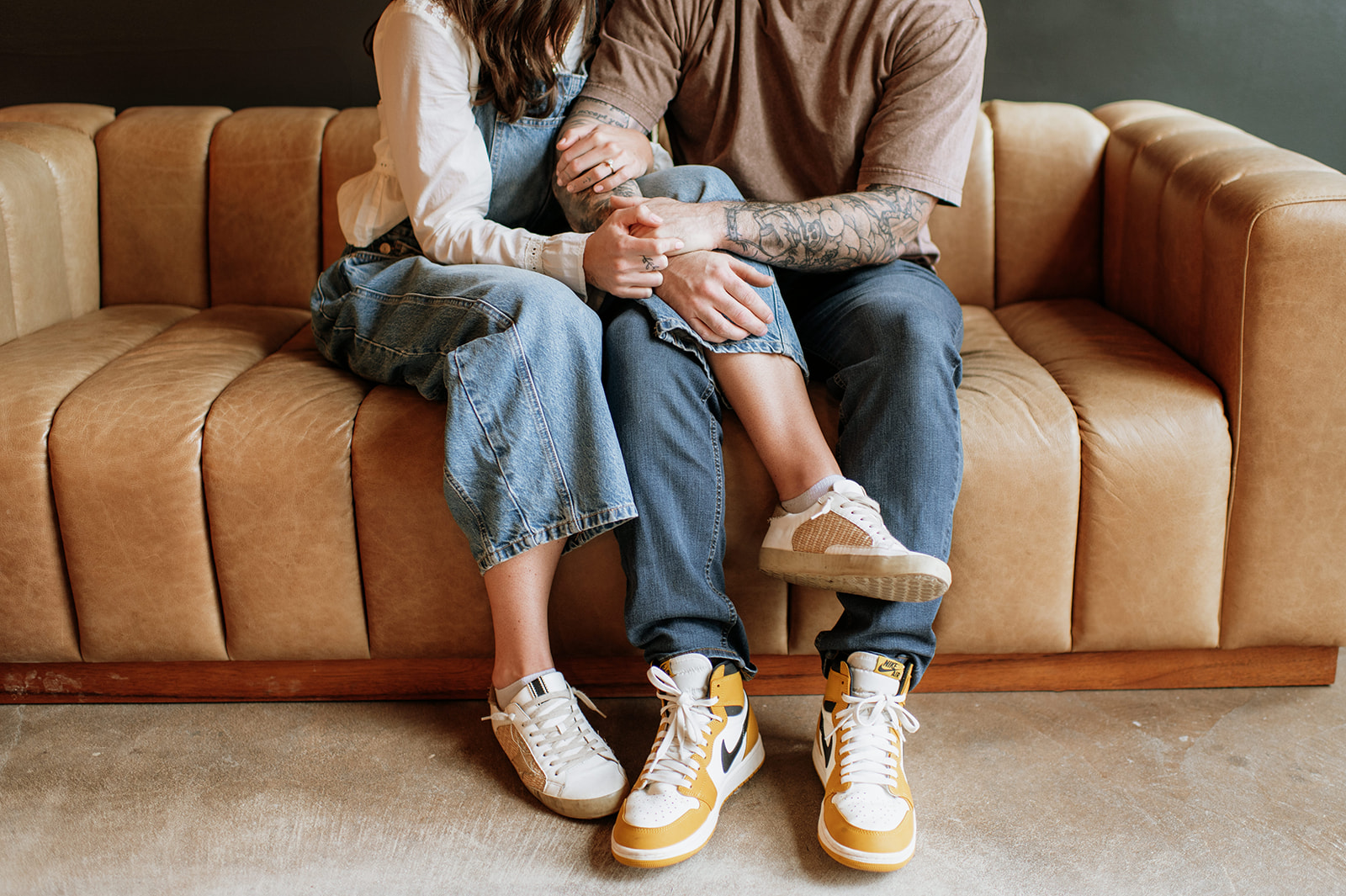 Close up shot of a couple sitting together on a couch.