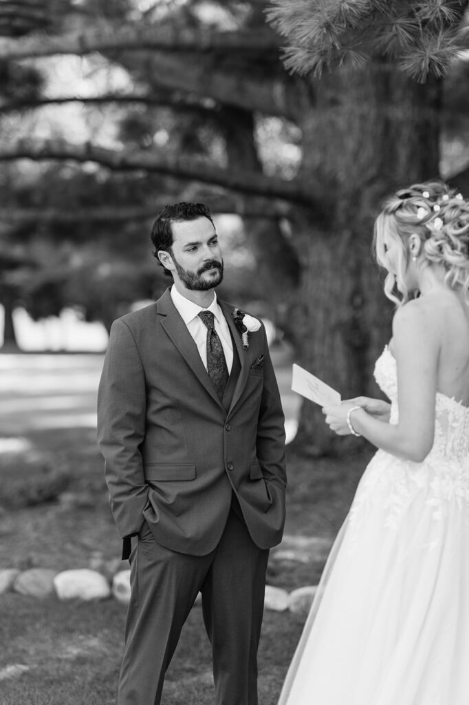 Black and white photo of a bride and groom exchanging private vows at The Lodge at Rush Lakes in La Porte, Indiana. 