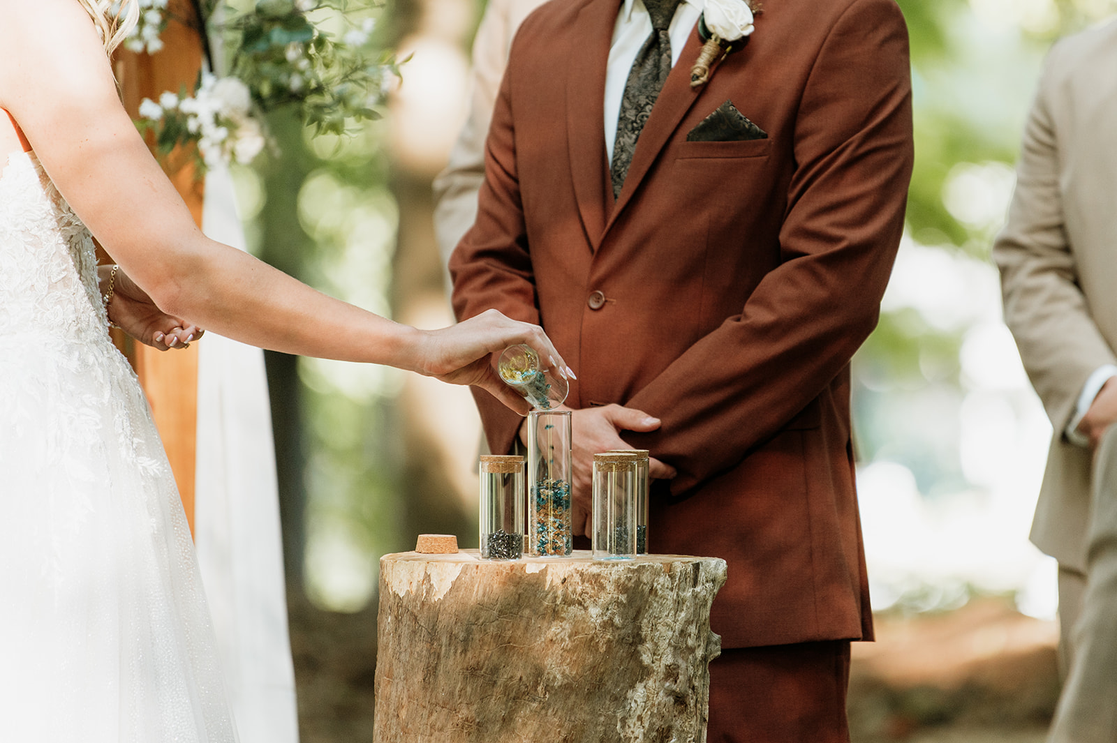 Close up of a bride and groom performing a unity ceremony. 