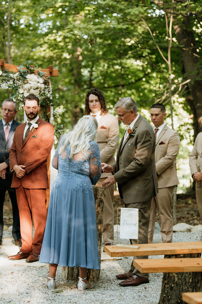 Bride and grooms family helping with their unity ceremony.
