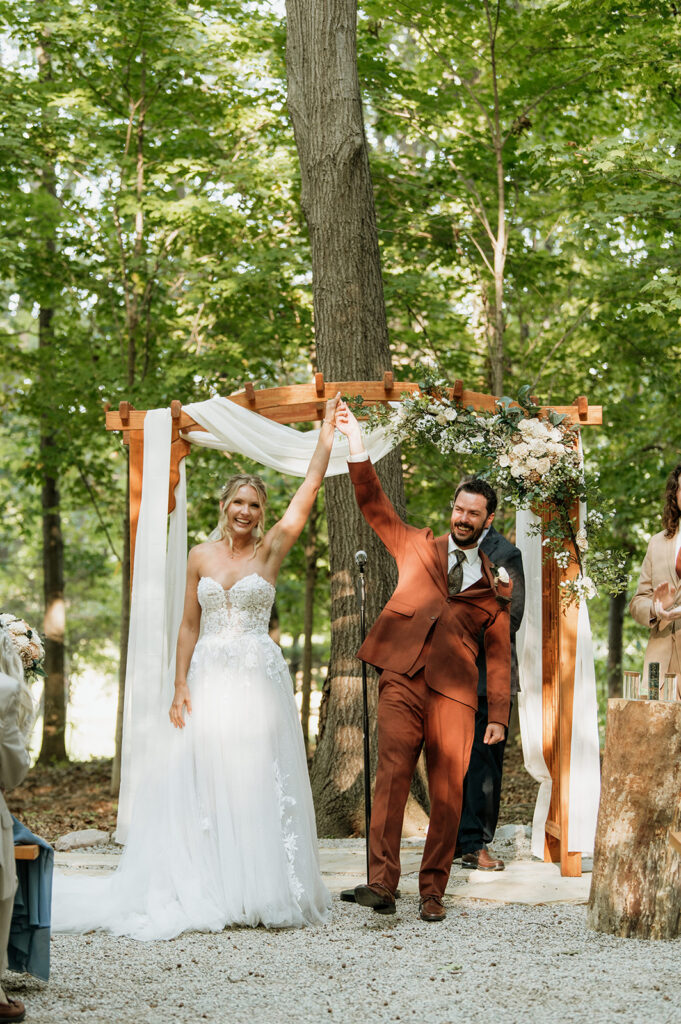 Bride and groom walking back down the aisle together after ceremony at The Lodge at Rush Lakes.