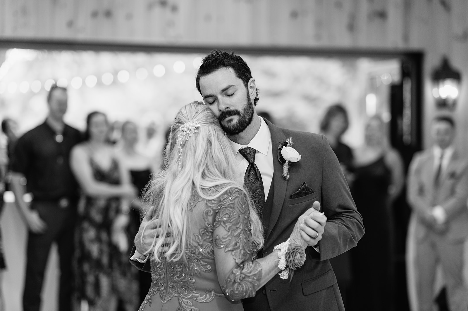 Groom dancing with his mother during a heartfelt mother-son dance at the wedding reception.
