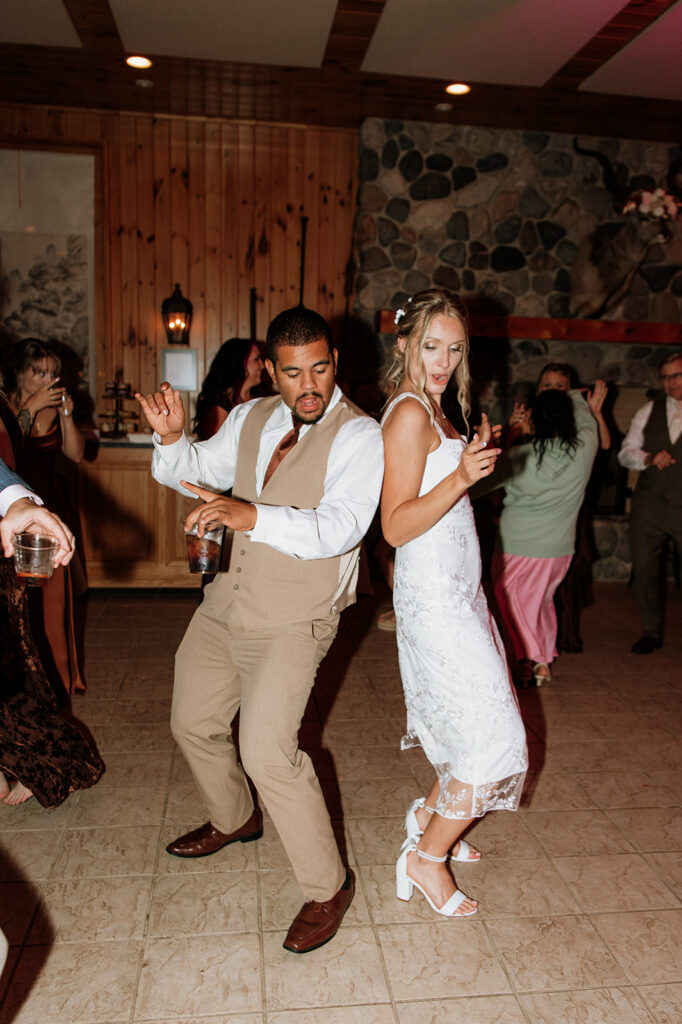 Bride dancing with a groomsmen.