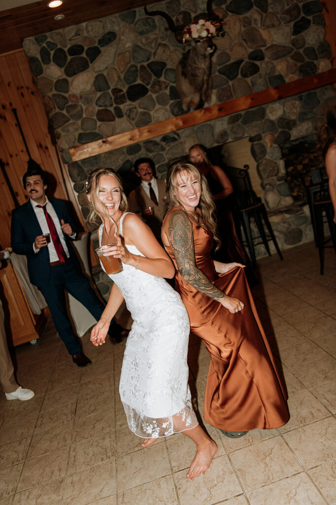 Bride dancing with a bridesmaid.