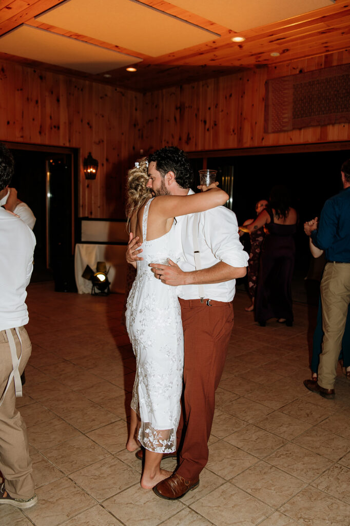 Bride and groom sharing a slow dance together at the end of the wedding reception.