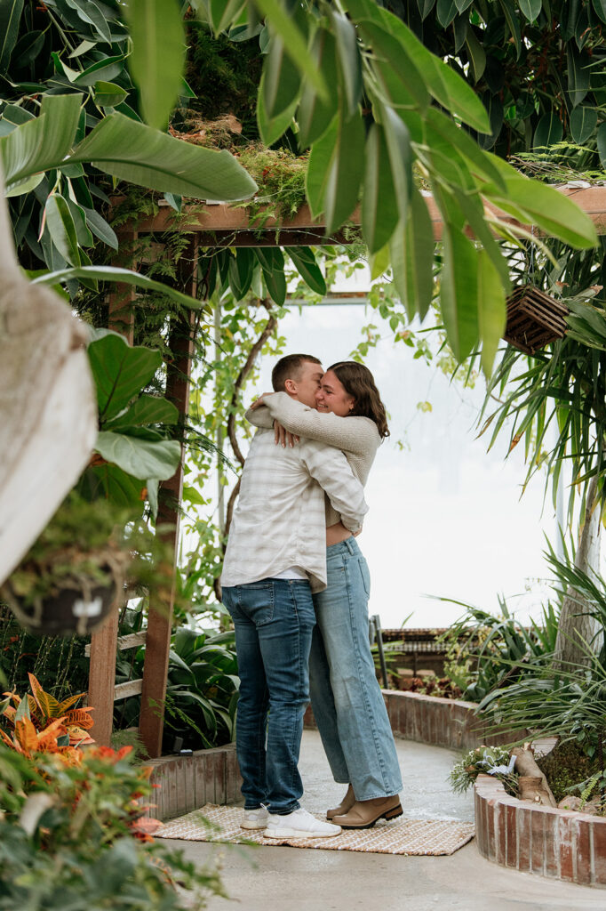 Woman hugging her fiancé after he proposed to her in South Bend, Indiana. 