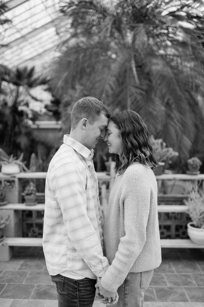 Romantic black and white portrait of couple after South Bend Indiana surprise proposal in conservatory.