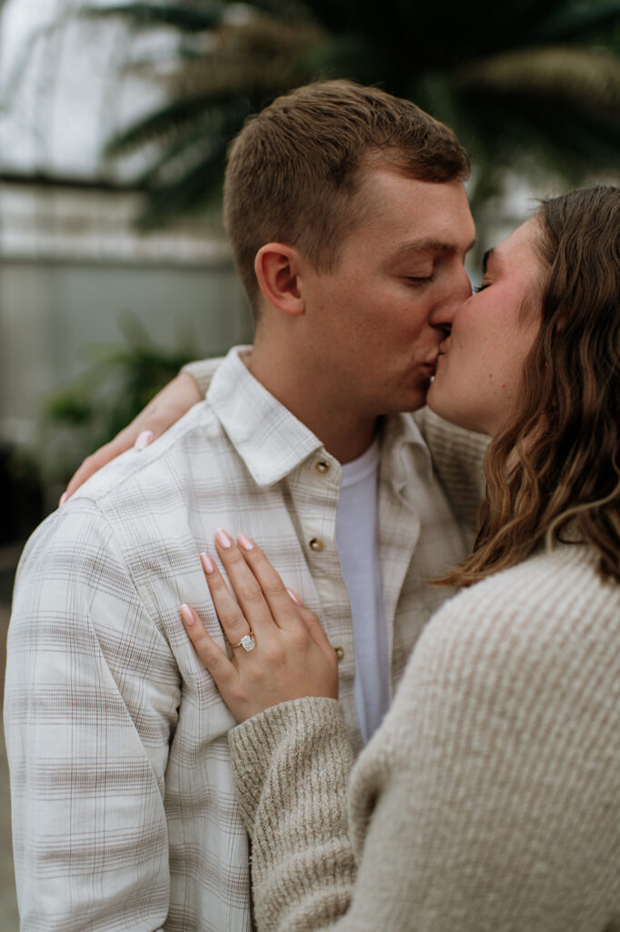 Couple kissing during their surprise proposal photoshoot.