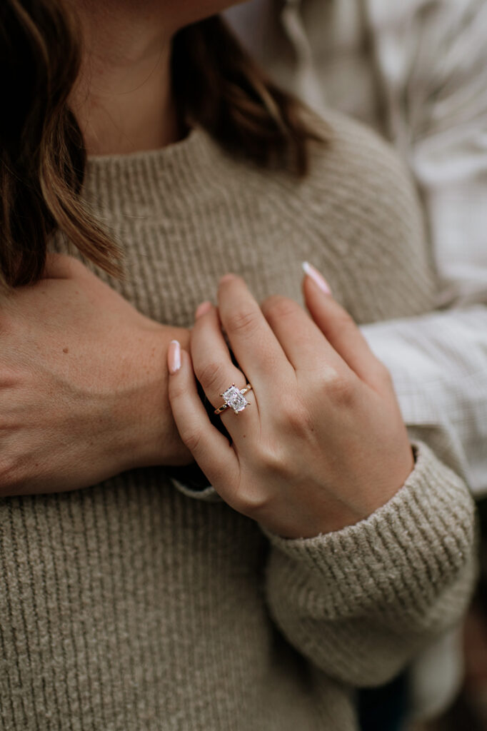 Detail of engagement ring on hand during South Bend Indiana surprise proposal session.