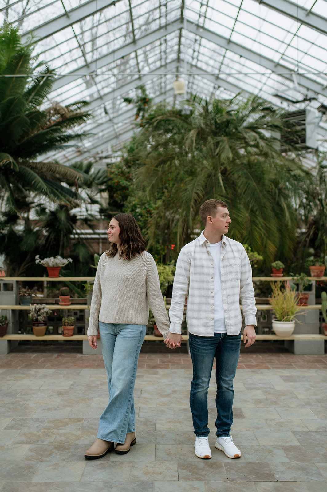 Couple holding hands inside of Potawatomi Conservatories.