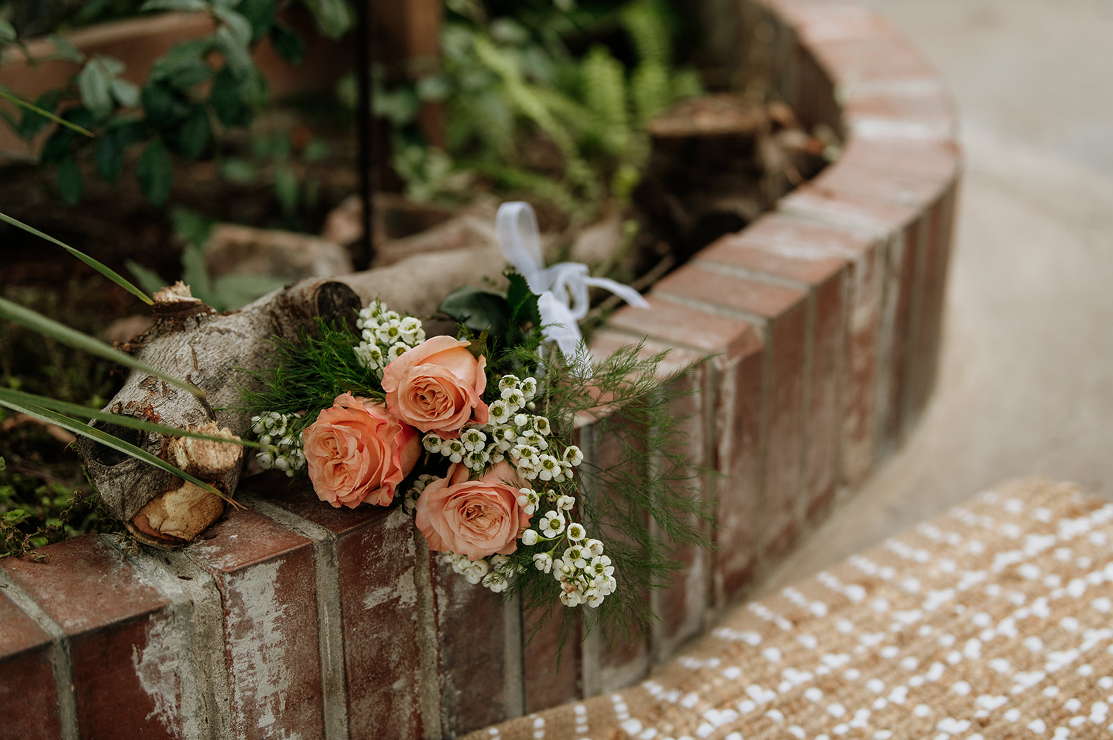 A floral bouquet resting on bricks at Potawatomi Conservatories.
