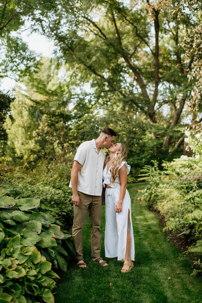 Couple kissing during their Hamstra Gardens engagement photos in the fall.