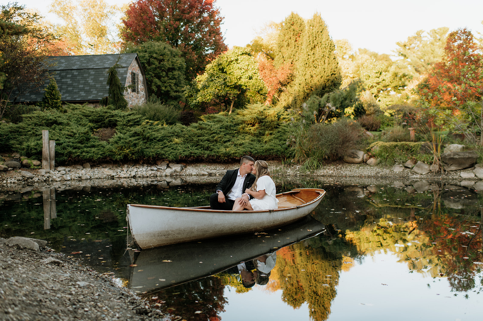 Couple kissing on a boat during their Hamastra Gardens engagement photos in Indiana.