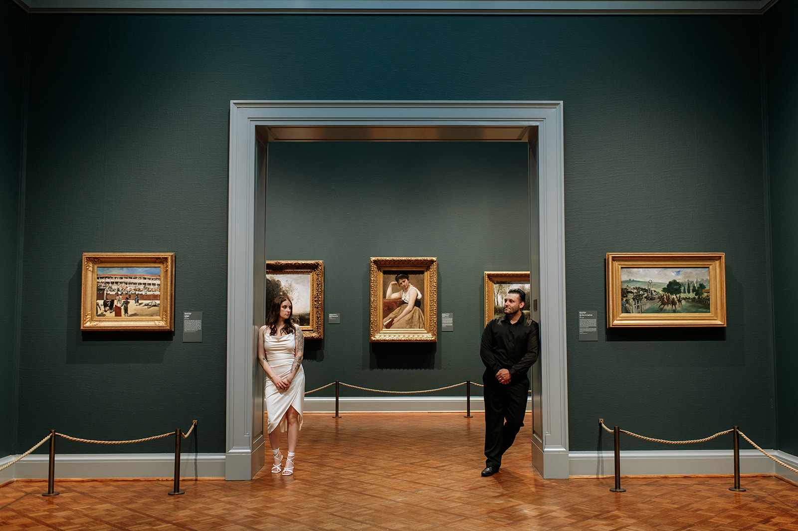 Couple posing in a museum for their Indiana engagement photos.