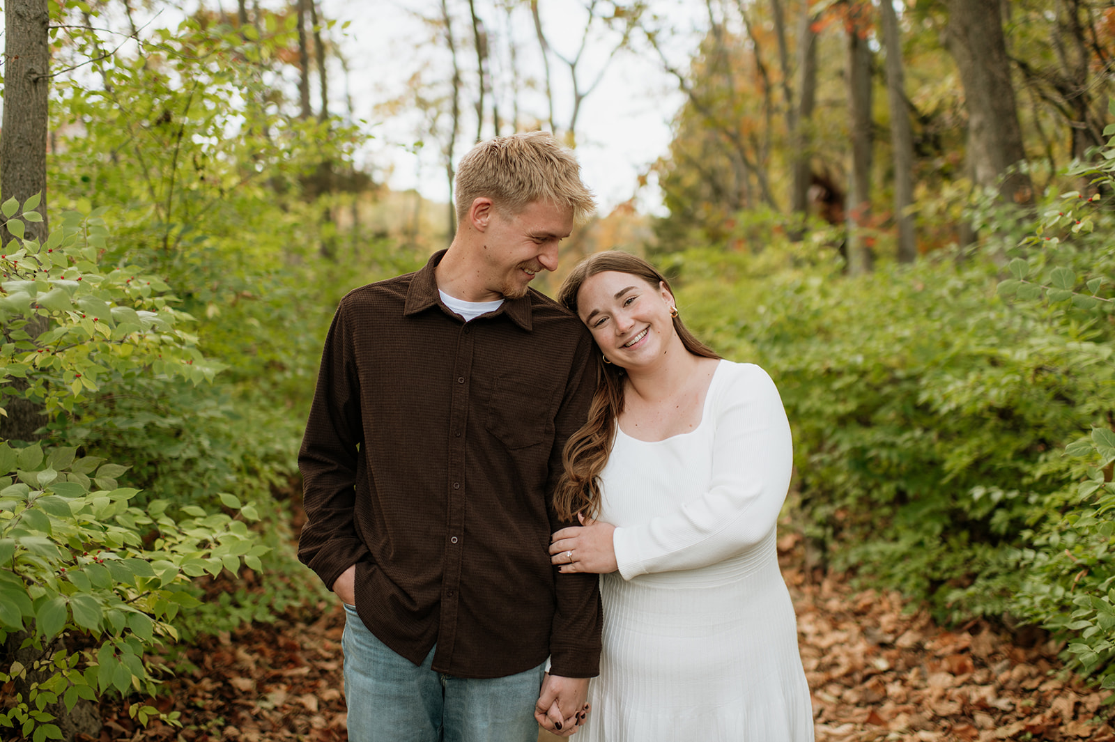 Couple posing for theur fall engagement photos in Northern Indiana.