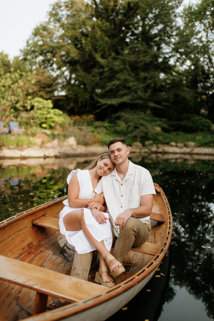 Couple posing in a boat during their Hamstra Gardens engagement photos in Indiana.