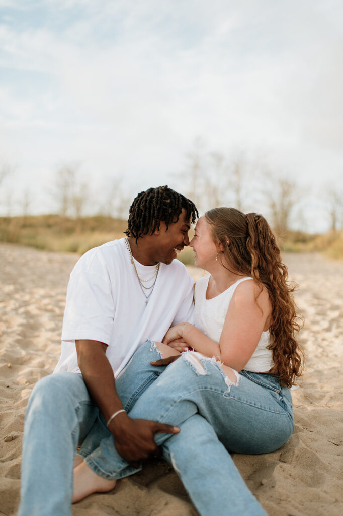 Couple laughing during their beach engagement photos in New Buffalo. 