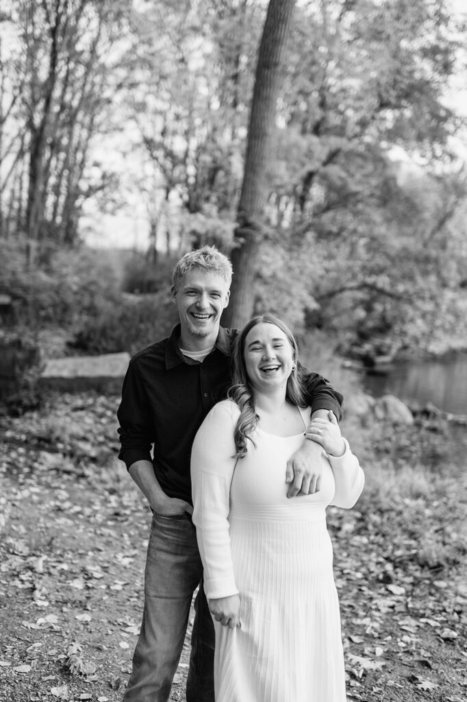 Black and white candid photo of a couple laughing during their South Bend engagement photos at St. Patrick’s County Park.