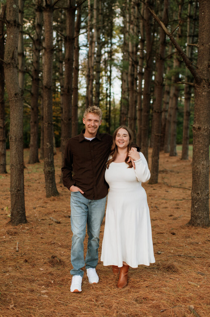 Couple smiling as they pose for their fall session.