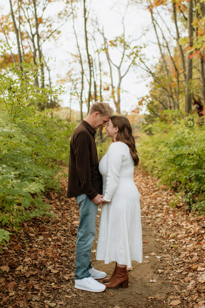 Couple touching foreheads during their outdoor fall South Bend engagement photos at St. Patrick’s County Park.