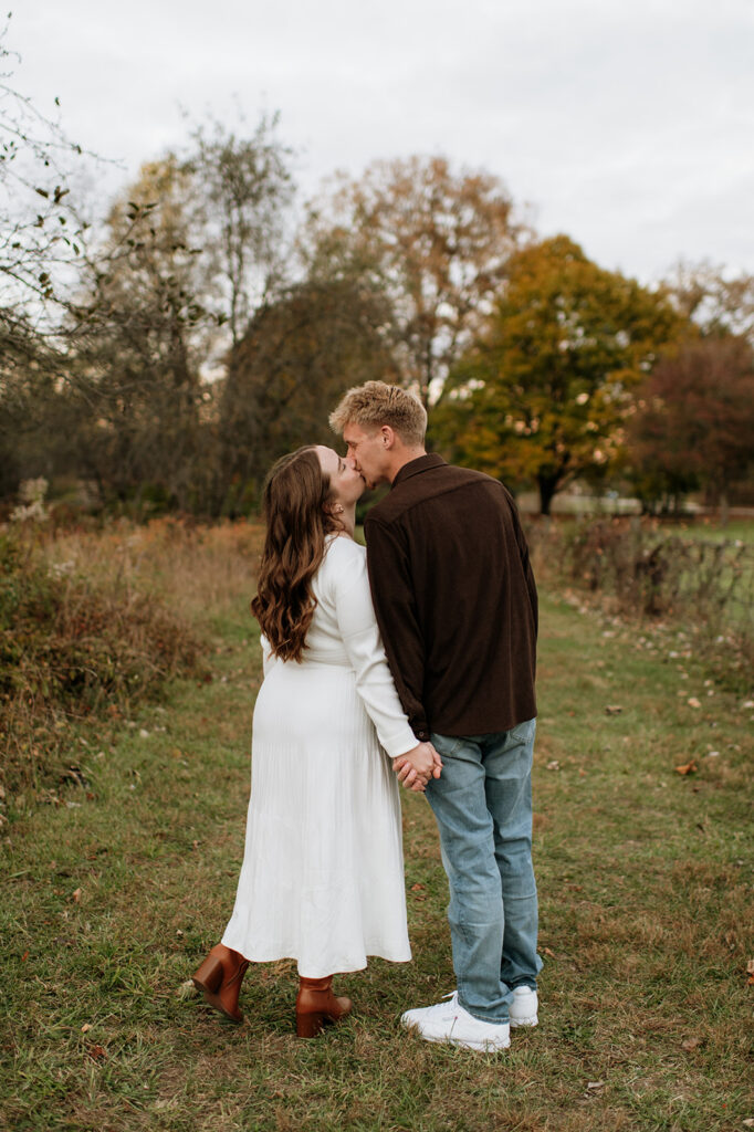 Couple kissing during their South Bend engagement photos at St. Patrick’s County Park.