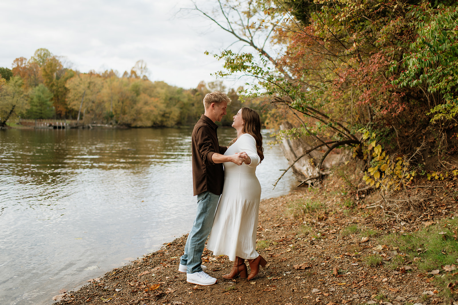 Couple dancing during their outdoor fall engagement photo session.