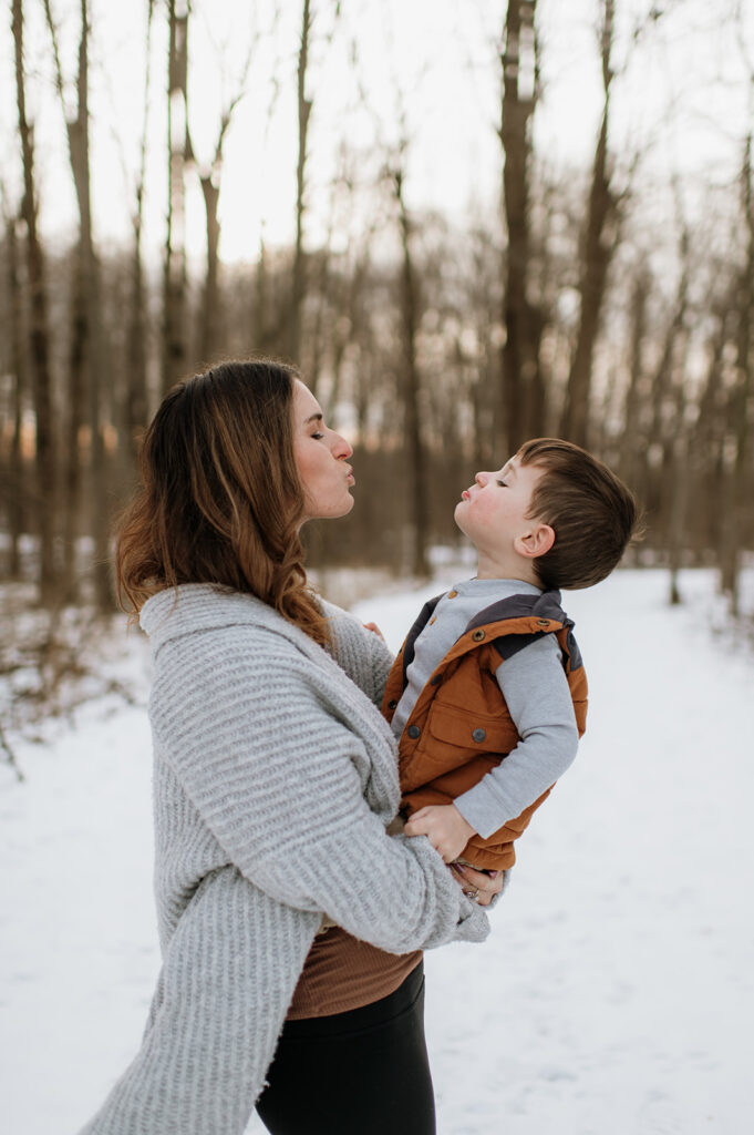 Mother and son blowing each other kisses for their Northern Indiana family photos at Potato Creek State Park.