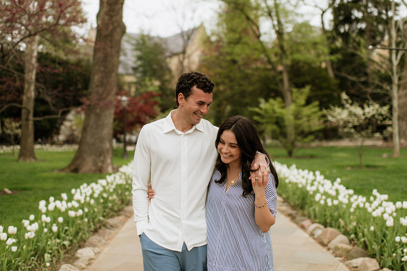 Couple walking on campus at Notre Dame for their engagement photos.