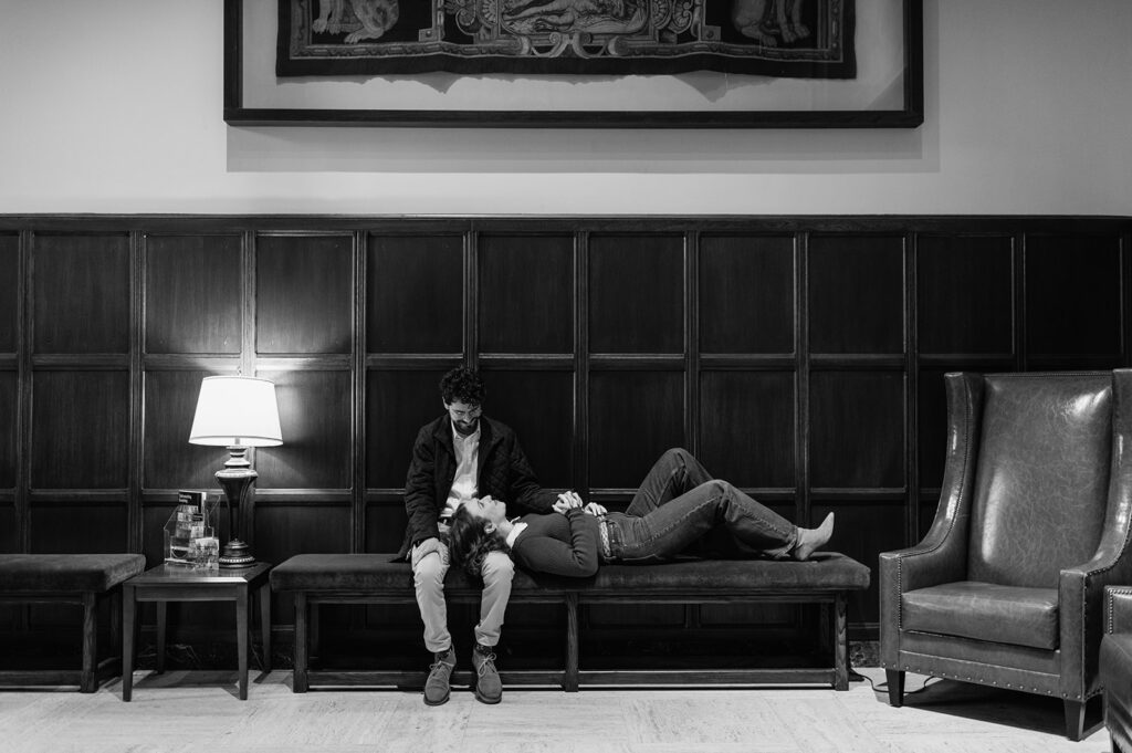Black and white photo of a couple posing inside of University of Notre Dame for their engagement photos.