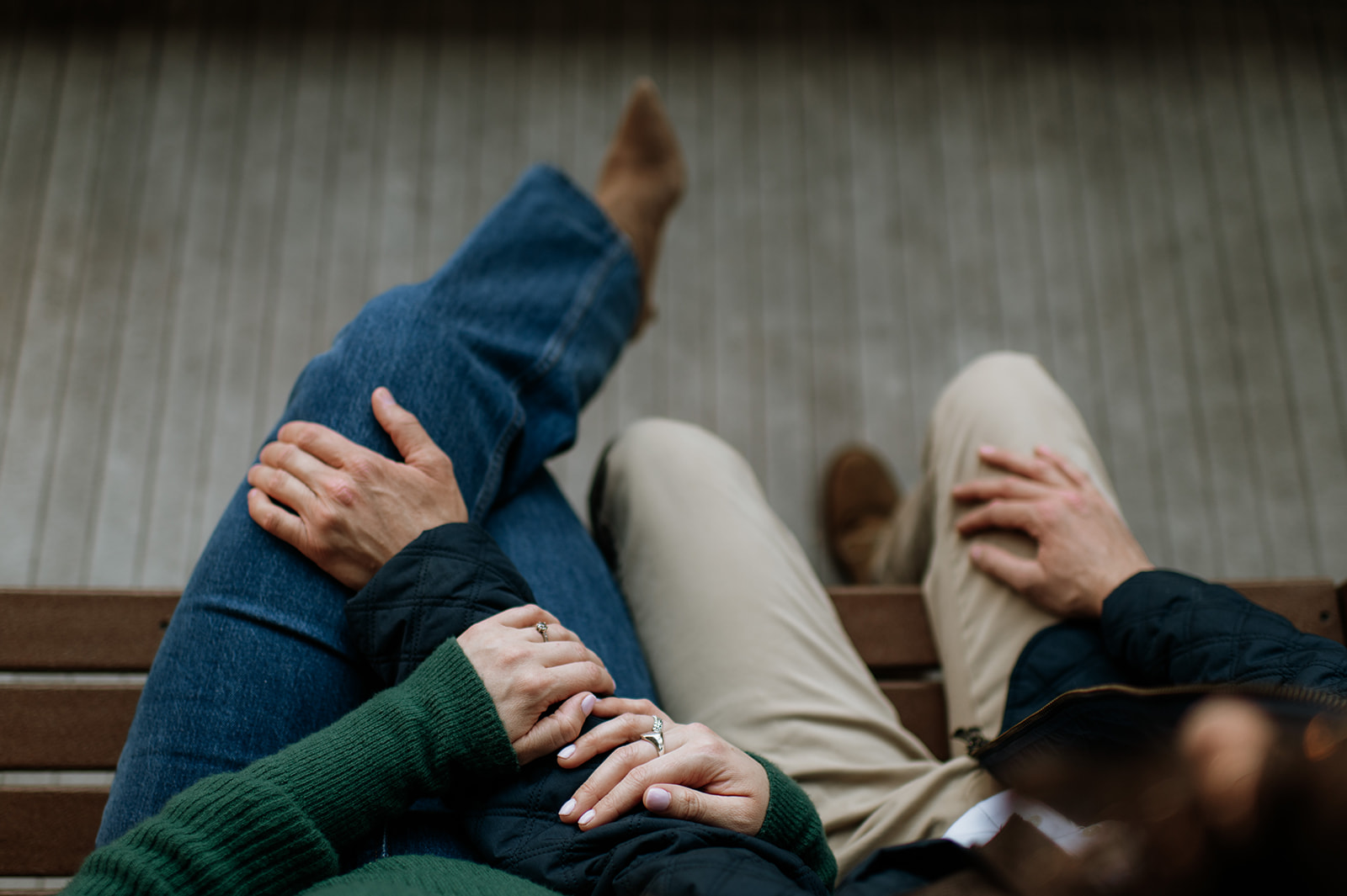Overhead photo of a couple snuggled up on a bench for their University of Notre Dame engagement photos.
