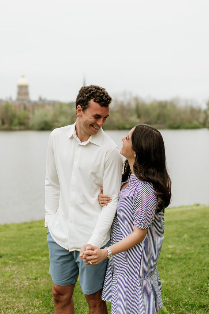 Man and woman smiling at each other in front of Saint Joseph’s Lake.