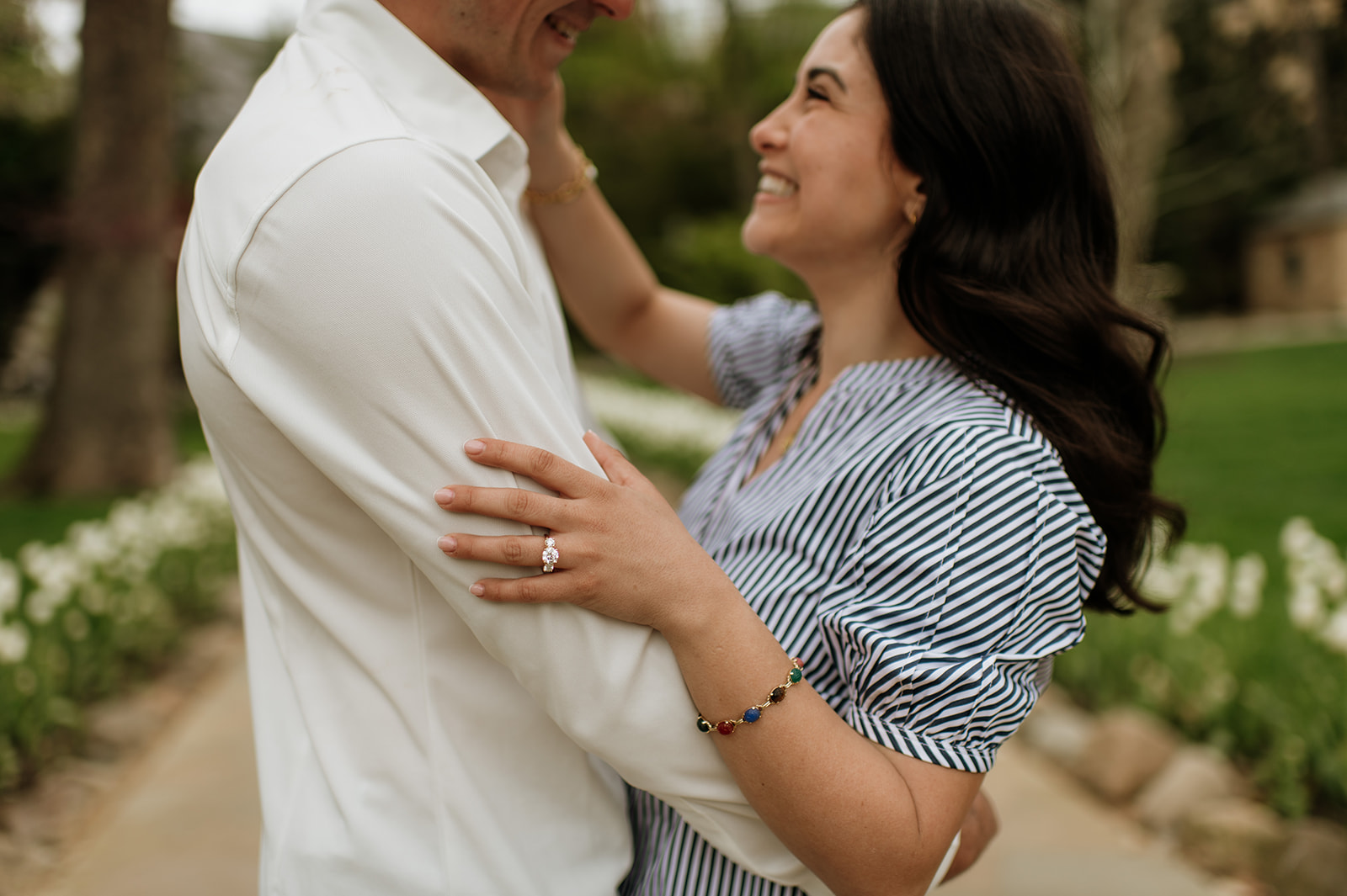 Close up shot of a couple posing near the Grotto at Notre Dame after their proposal.