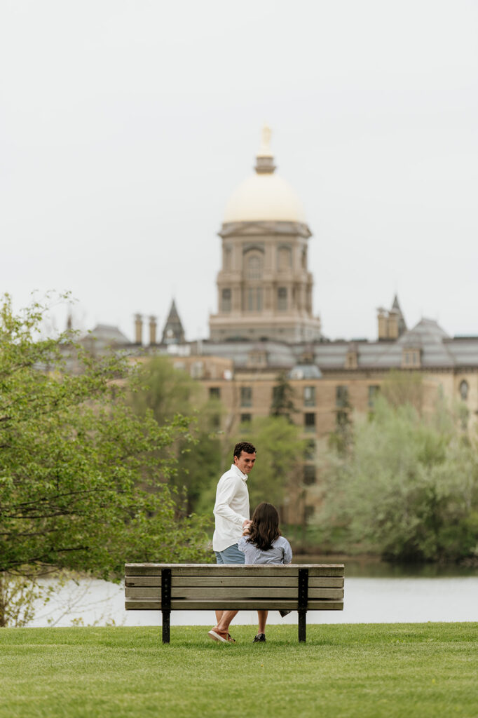 Man standing up and leading his soon to be fiancé over to a spot to propose.