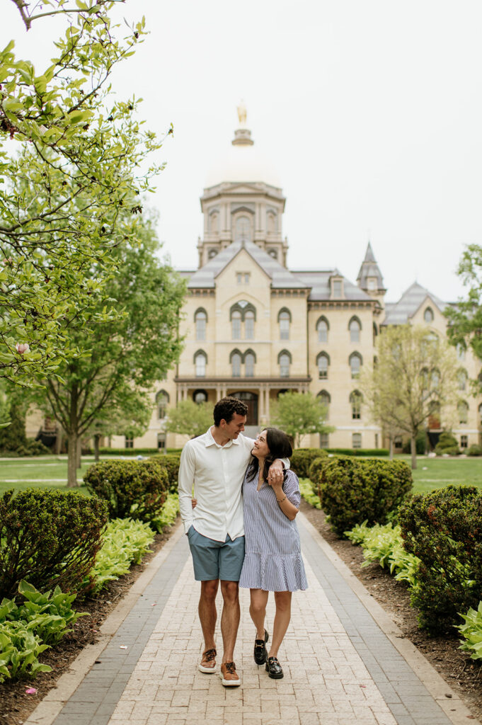 Couple walking together in front of the Golden Dome.