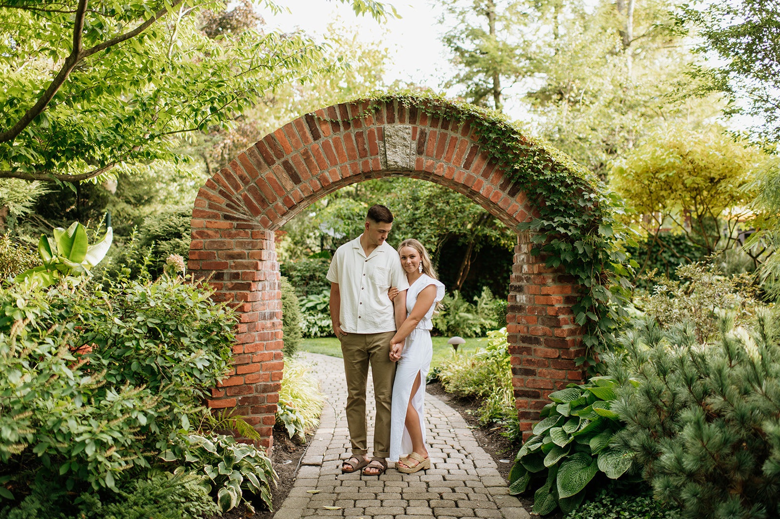 Couple posing for engagement photos at Hamstrsa Gardens in Northern Indiana - a Northern Indiana Photo Location.