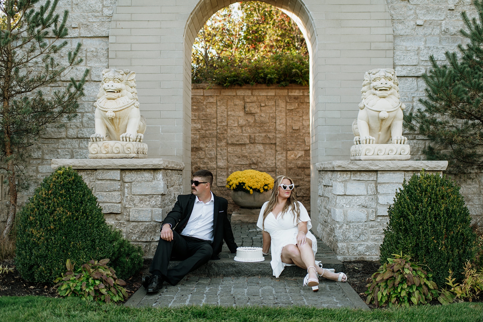 Couple posing inside of Hamstra Gardens for their Northern Indiana engagement photos.